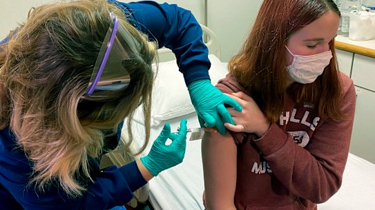 Teenager Katelyn Evans gets a Pfizer vaccination in a trial in Cincinatti 