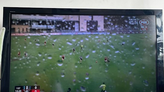 A wet TV camera makes it difficult to follow Port Adelaide’s game against Essendon at Alberton Oval last year.