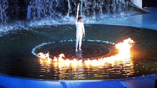 Freeman waits for the cauldron to rise after lighting the flame.