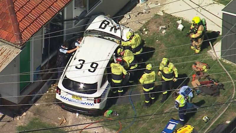 Officer trapped in cop car that crashed into western Sydney home