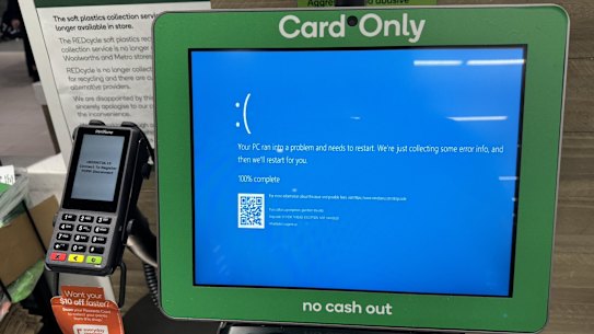 An self-checkout register at Woolworths displays a blue screen as companies nationwide report IT outages.