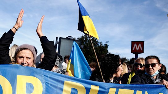 Demonstrators holding a banner with the Ukraine national colours in Rome.