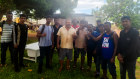 A group of the suspected asylum seekers with members of the Indigenous community where they first made contact.