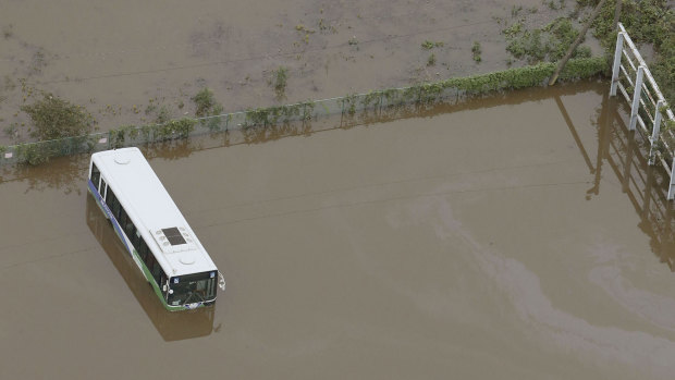 Busses are submerged in floodwaters after torrential rain in Sakura city, Chiba prefecture.