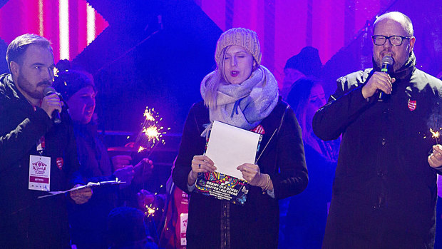 Gdansk Mayor Pawel Adamowicz, right, speaks to an audience shortly before he was stabbed in Gdansk, Poland.