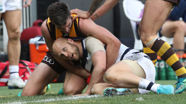 Contained: Gary Ablett is heavily tackled.