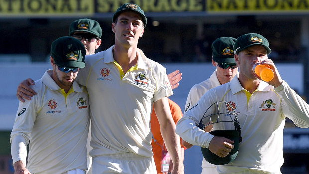 Respite: The Australians enjoy their win as they walk off the Gabba on day three.