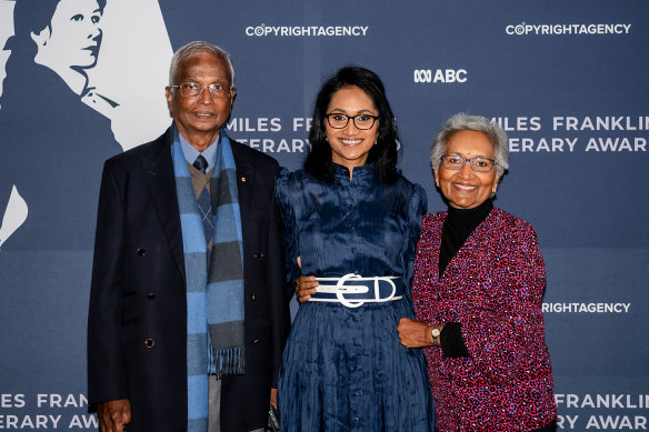Shankari Chandran with her parents, neurosurgeon Dr Nadana Chandran and now-retired GP Dr Rathy Chandran, at the Miles Franklin award ceremony last July.