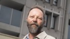 Hold up: David Proctor is trying to sell an apartment in a building with combustible cladding that experts say is safe, but the regulator still officially regards as non-compliant with the building code. 