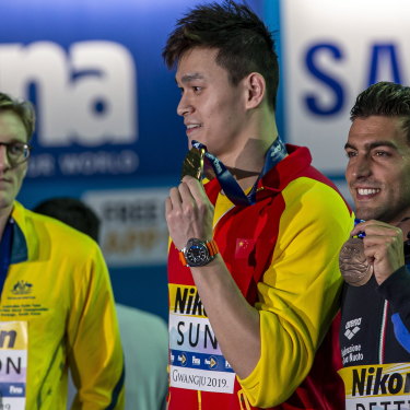 Mack Horton (left) makes his point as Sun Yang (centre) accepts his gold medal at the 2019 world championships.