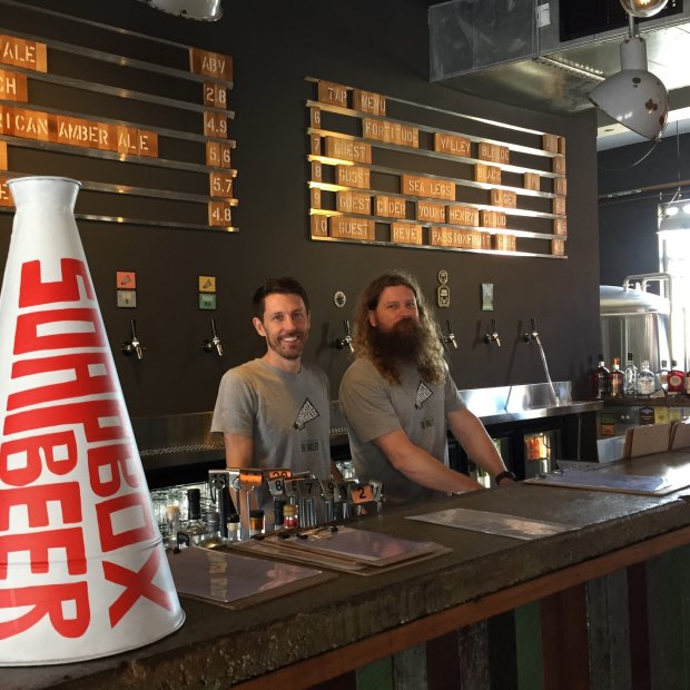 Scott Robertson and Luke Nixon, owners of Soapbox Beer in Fortitude Valley, at the bar in their new craft beer pub.