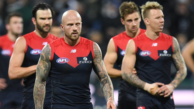 Not again: Demons players walk from the field after another shattering loss.
