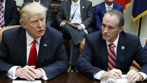 Republican Congressman Chris Collins (right) pictured with Donald Trump. Collins has been arrested by the FBI.