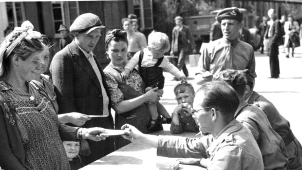 Families receive new papers in Hamburg following the end of the war.