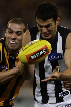 Lance “Buddy” Franklin and Chris Tarrant vie for the ball.