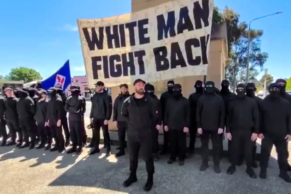 The men, believed to be part of a white-supremacist group, gather in front of the Corowa war memorial.