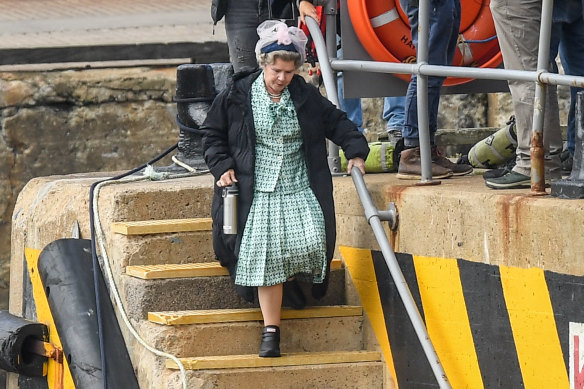 Imelda Staunton boards a boat, with personal water bottle and puffer coat, for a scene as the Queen in Macduff, Scotland, earlier this month.