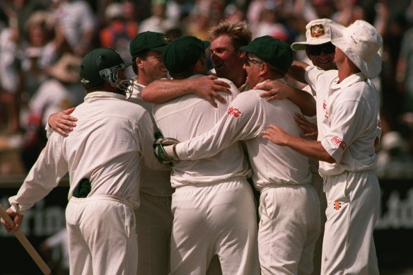 Sweet victory: Teammates mob Shane Warne after the final wicket falls in Kingston to seal Australia's famous series win.