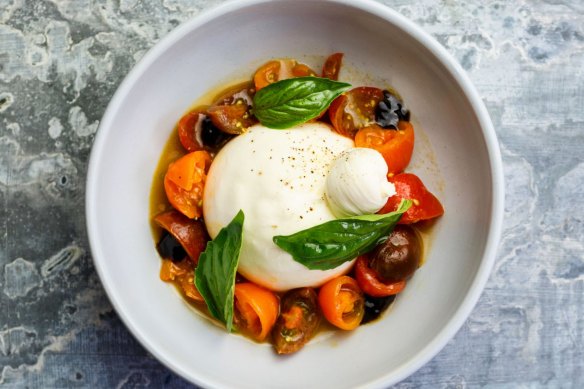 Burrata, macerated tomatoes, aged balsamic vinegar, and basil at Brunetti Flinders Lane, Melbourne.