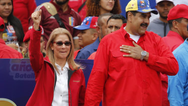 Venezuela's President Nicolas Maduro and first lady Cilia Flores acknowledge supporters at the end of a rally in Caracas on  Saturday.