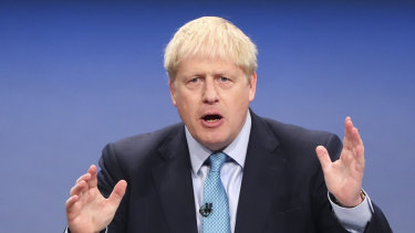 UK Prime Minister Boris Johnson gestures while delivering his keynote speech.