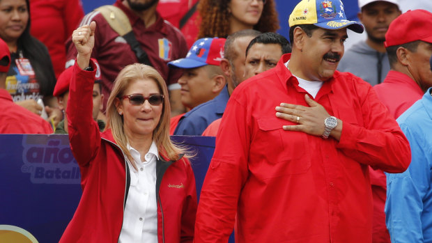 Venezuelan President Nicolas Maduro and first lady Cilia Flores acknowledge supporters at the end of a rally in Caracas.