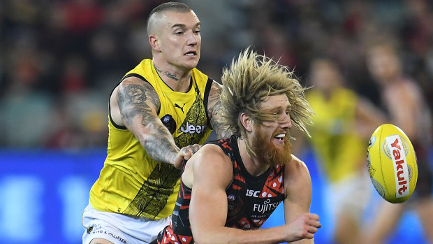 Tigers star Dustin Martin doesn't give Bombers captain Dyson Heppell an inch.