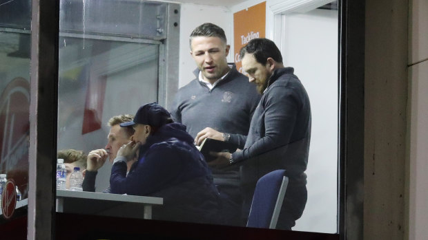 Sam Burgess watches on from the Warrington coaching box.