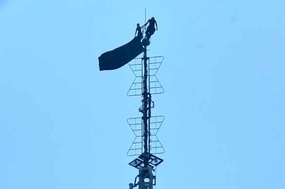 The couple scaled the top of the antenna, which reaches 443.2 metres above the ground, without safety equipment.