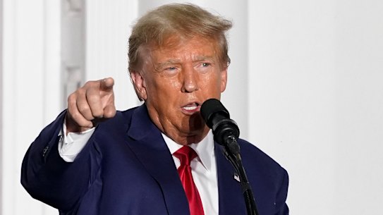 Former President Donald Trump speaks to supporters at Trump National Golf Club.