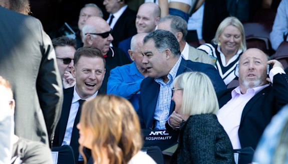 Mal Meninga and Ben Fordham watch on at the memorial.