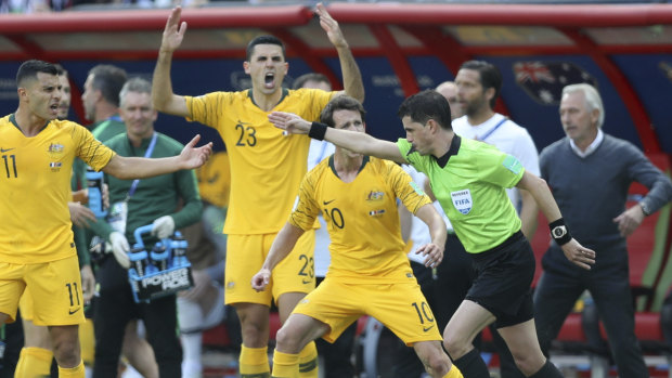 The Socceroos react after referee Andres Cunha consults VAR on the penalty.