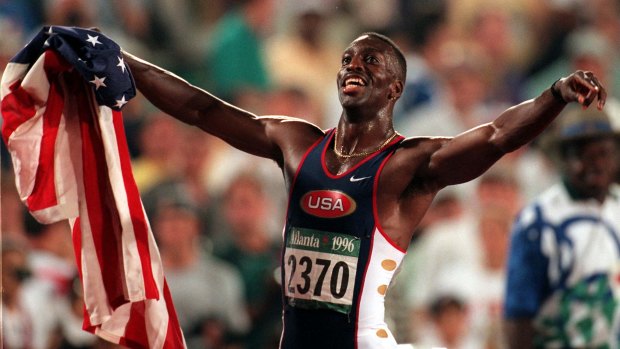 Michael Johnson of the United States celebrates after winning gold in the men's 200 metres in a new world record time of 19.32 at the 1996 Summer Olympic Games.