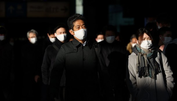 Commuters wear face masks in Tokyo earlier this month. 