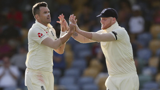England duo James Anderson (left) and Ben Stokes celebrate a wicket on day one.
