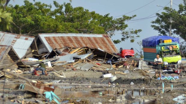 A man stands amid the damage caused by a tsunami in Palu.