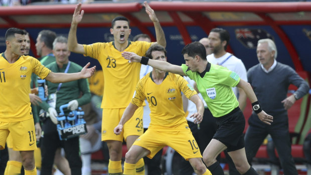 Spot fire: The Socceroos react after referee Andres Cunha consults VAR on the penalty.