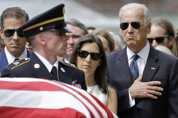 Joe Biden at his son Beau’s funeral next to his widow Hallie and brother Hunter.