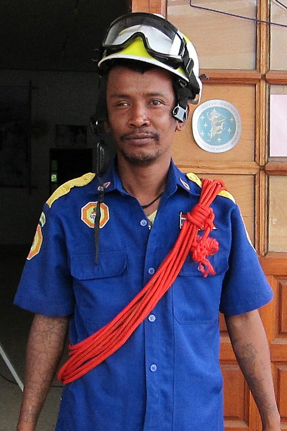 A volunteer getting ready for the day's work plugging holes as part of the cave rescue effort.