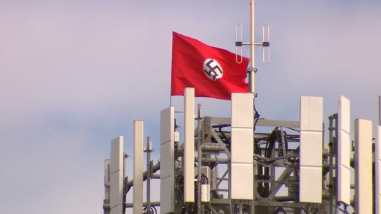 A large swastika has been planted on the top of a phone tower at Kyabram. There are also two Chinese flags being flown from there too. 