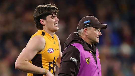 Will Day hobbles off Adelaide Oval.