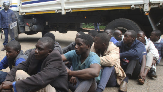 A policeman stands guard as protesters are arrested in Harare on Wednesday. 