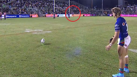 A Panthers trainer runs behind the posts while Reece Walsh lines up his conversion.
