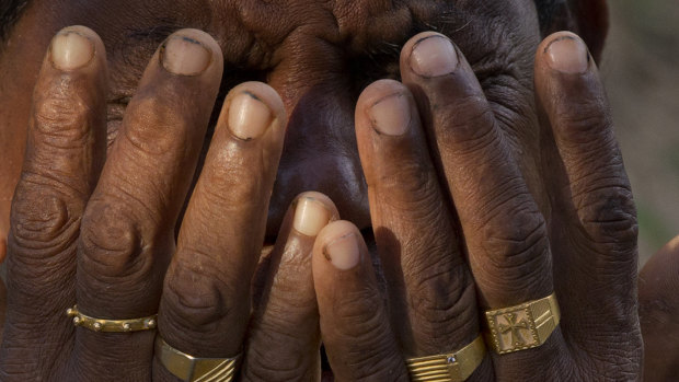 Melton Roy prays at a mass burial for Easter Sunday bomb victims in Negombo, Sri Lanka, on Tuesday.