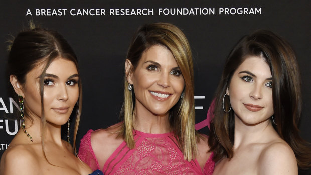 Lori Loughlin (centre) pictured with daughters Olivia (left) and Isabella, was charged with paying $US500,000 to ensure her daughters' entry to elite universities.