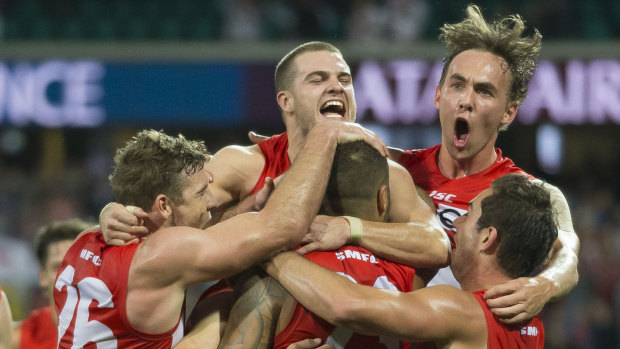True grit:  The Swans celebrate a Lance Franklin goal against West Coast on Sunday.