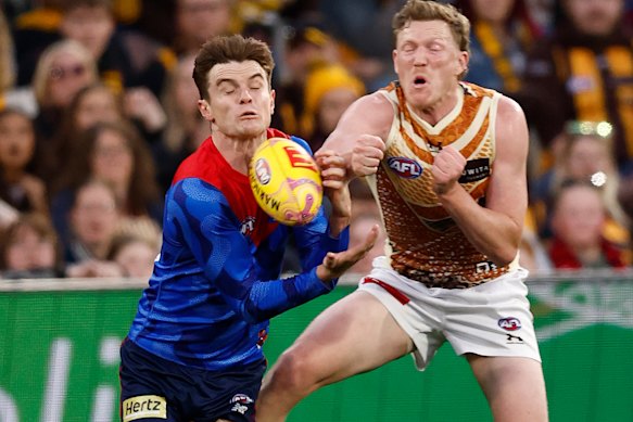 Bayley Fritsch of the Demons and James Sicily of the Hawks compete for the ball.