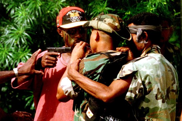 The personal bodyguard of the sacked head of PNG's armed forces threatens another soldier during unrest in 1997.