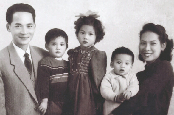 Andrew Kwong (second from right) is held by his mother in a family photo taken in the 1950s.