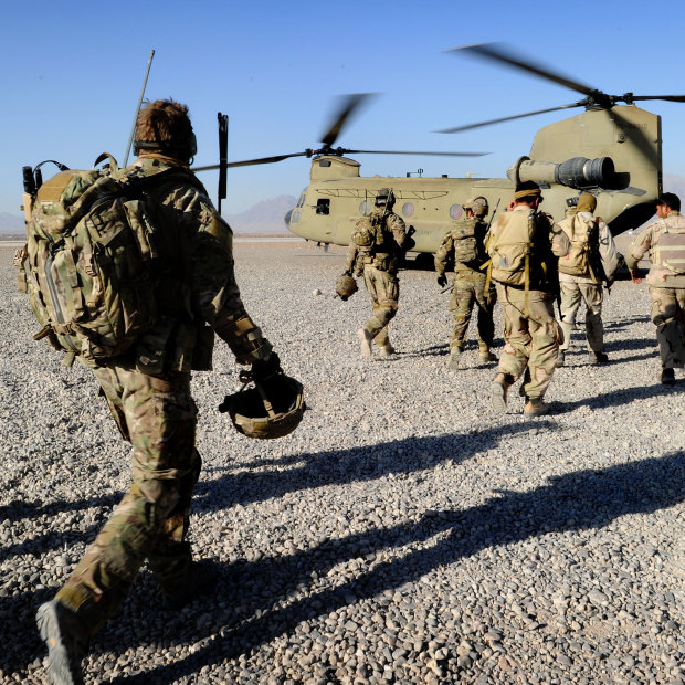 Australian troops from Special Operations Task Group and their Afghan counterparts from the Provincial Response Company walk to a CH-47 Chinook aircraft ahead of a mission.